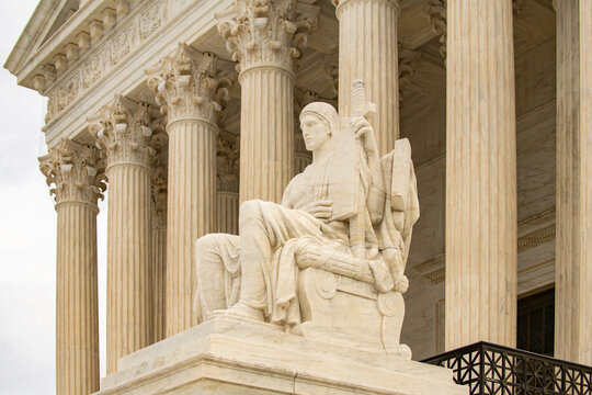 Justice statue classical marble exterior. Supreme court columns symmetry facade. Law constitution judicial governance authority. Legal background concept.