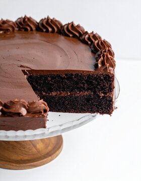 A rich Devil's food cake with creamy chocolate frosting on a minimalist white background
