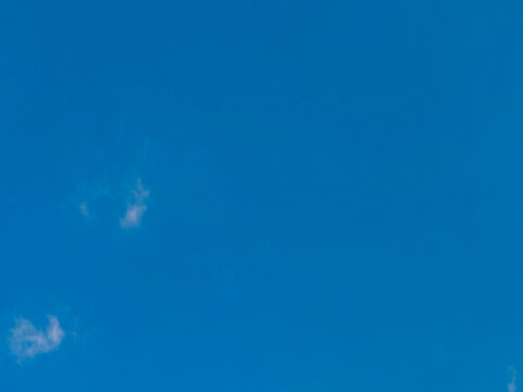  a clear blue sky with a few wispy, white clouds. Used as a clean canvas for digital wallpapers, graphic design, or presentation slides.