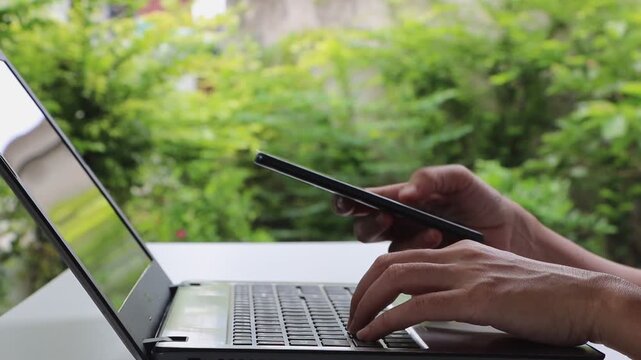Cybersecurity, Cyber security 2FA login concept. Businesswoman working on laptop logging in on smartphone and modern device. Concept of remote work, freelancing, paying, banking, online shopping.