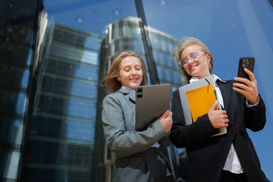 Business professionals collaborate outside a modern skyscraper during a bright sunny day