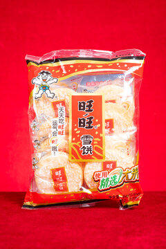 ZHONGSHAN China-February 12 2026: Want Want crispy rice snow crackers packaged in transparent red snack bag.
