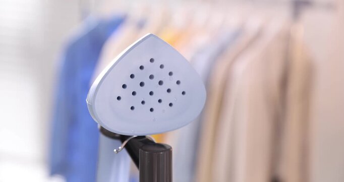 Modern upright steamer with stand indoors, closeup
