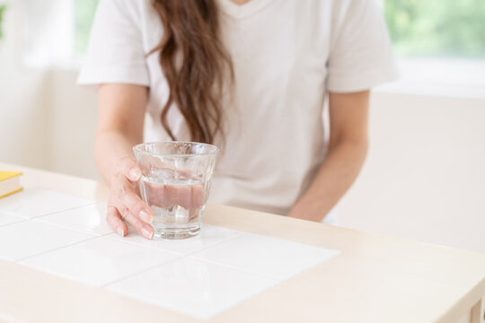 水を飲むシニア女性　手元