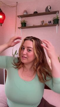 running hands through hair applying batana oil