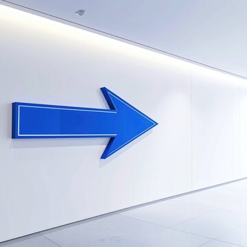 Large blue arrow points right on a clean, modern white wall