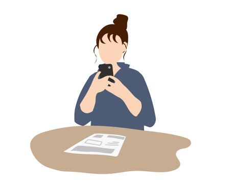 スマホを見ながら資料を確認する若い女性