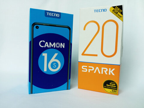 Two Tecno smartphone paper boxes package on white background. Camon 16 S and Spark 20 phone box designed by Tecno. Double Android phones. Same brand, different model. Kumasi, Ghana - December 9, 2025