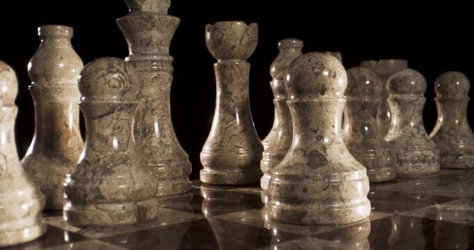 Close-up of a hand moving a chess piece on a chessboard