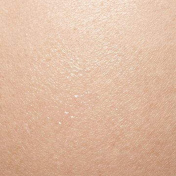 Close-up macro photograph of smooth human skin texture with fine pores