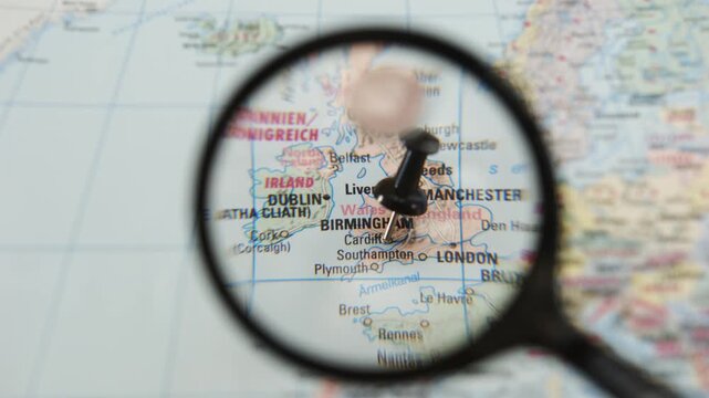 Magnifying glass highlights Dale, Cardiff on a paper map of Europe