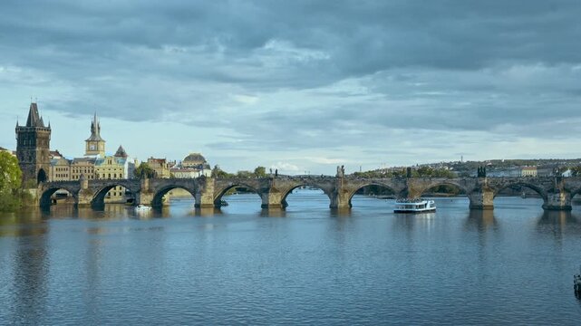 Wide view of the historic Charles Bridge and Old Town tower over the Vltava River at dusk, Prague landmarks, Czechia