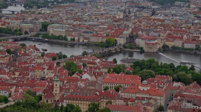 High angle aerial view of historic Old Town roofs and bridges over Vltava River in Prague, Czechia.