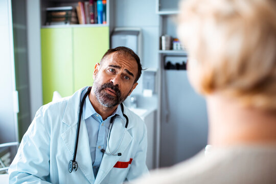 Concerned doctor consulting patient in clinic