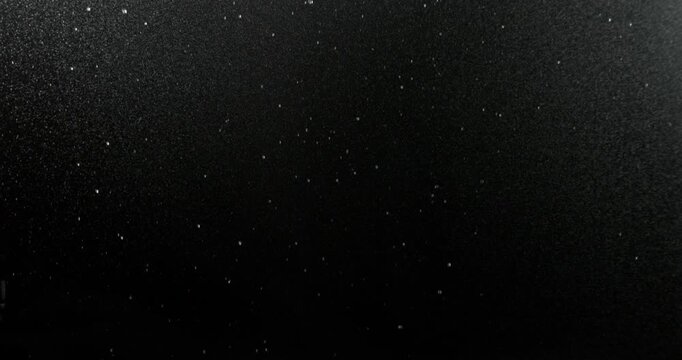 Ultra slow motion fine rain mist falling on a black background. High-quality VFX overlay for cinematic compositing, weather simulations, motion graphics, title sequences and visual effects.