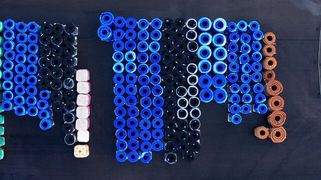 Top Down Drone View of Organized Plastic Pipe Storage Yard in Latvia