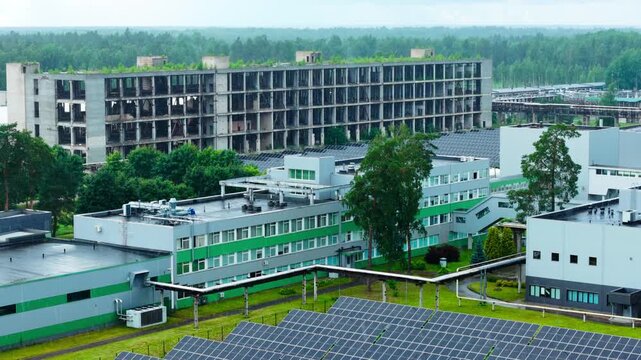 Renewable technology contrasts abandoned Soviet structure within modern industrial zone