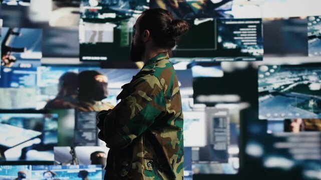 Young soldier works inside a command center, integrating satellite surveillance, intelligence data and digital warfare tactics for a national defense mission.