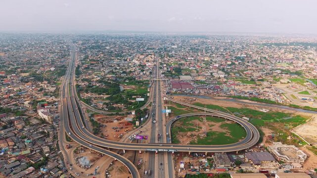 Aerial view of N1 highway interchange crossing a densely populated urban landscape in ghana