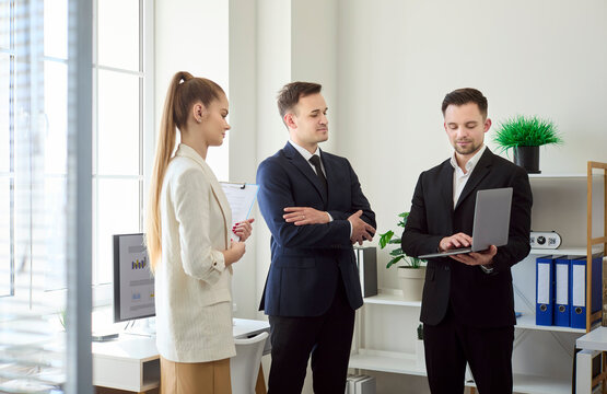 Team business colleagues meeting in modern office. Active discussion with teamwork and planning as an executive presents communication and strategy on a laptop. Solid team strategy for growth.