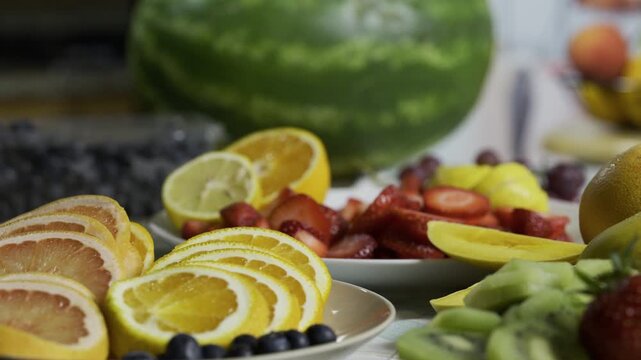 Slow motion tracking shot across delicious looking fruit on kitchen counter