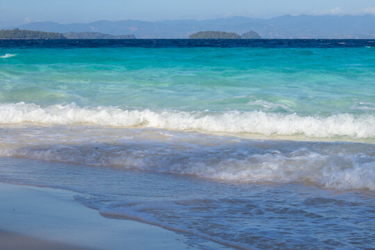 Turquoise Ocean Waves Crashing on Sandy Beach