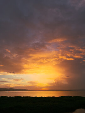 Sunset Over Water with Dramatic Clouds