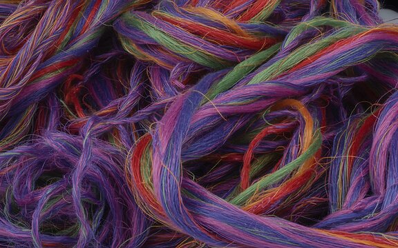 Colorful twisted yarn texture background with vibrant multicolor wool fibers
