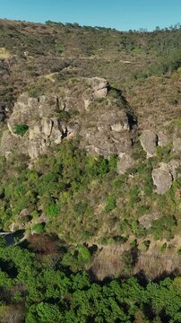 Vertical aerial orbit of El Nido del Zopilote and Piedrotas Los Compadres in Las Pe&ntilde;as Ecological Park, Jalisco