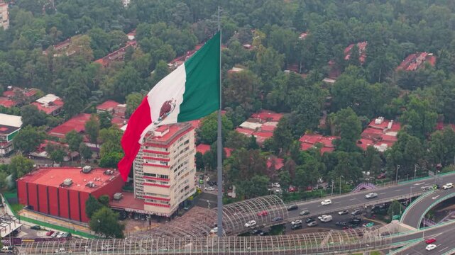 Aerial footage of giant Mexican flag above Periferico Sur, CDMX