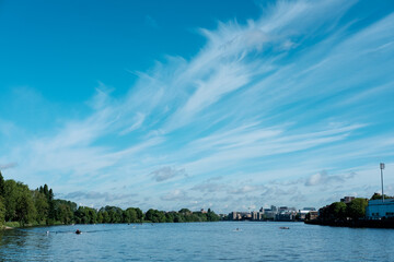 River scene with rowers enjoying summer day © Jorge Elizaquibel