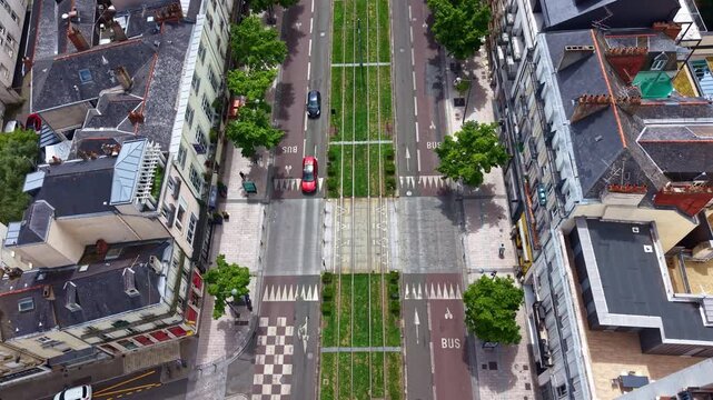 Top-down drone view flying above Boulevard du Mar&eacute;chal Foch, revealing tramway tracks, surrounding streets and downtown Angers, France.
