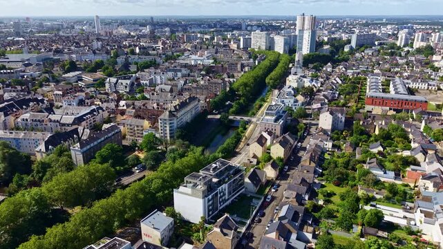 Drone pulling back and ascending above Rennes, revealing the Vilaine River, Tour des Horizons and the cityscape stretching to the horizon.