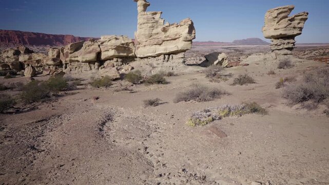 Weathered rock formations rise from the desert in Ischigualasto Provincial Park Argentina, establishing tilt upward