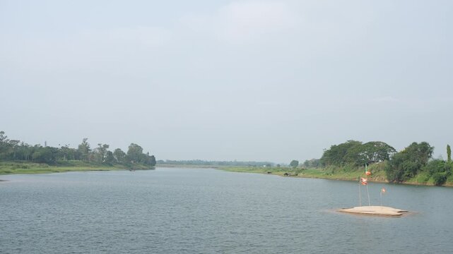 Flags of Indian political parties are being hoisted on the river sandbar.