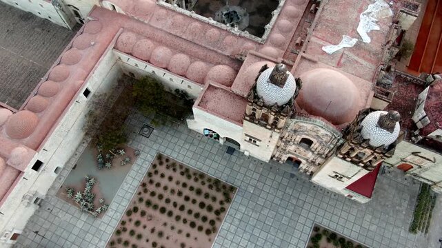 Aerial drone view of Santo Domingo de Guzman Church and former convent complex surrounded by Oaxaca City during early morning in Oaxaca, Mexico