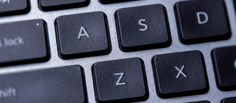 Close-up of a keyboard showing the letters A, S, D, Z, and X. The black keys have white lettering, demonstrating a modern laptop's design and functionality.