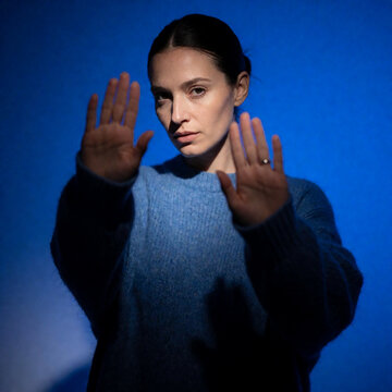 young woman showing stop sign