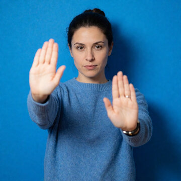 young woman showing stop sign