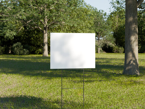 Blank yard sign mockup in park setting with trees and green grass