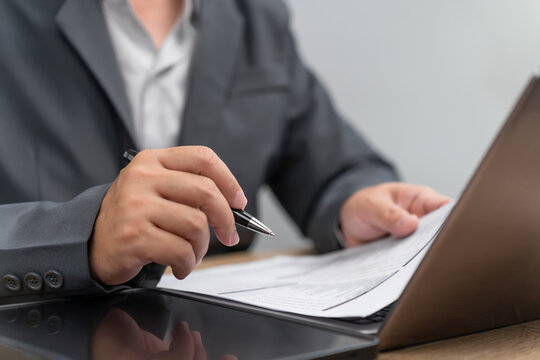 Risk and Financial Security Concept, Businessman Review Insurance Documents, Checking Coverage Terms with Pen, Policy Benefits Verification, Insurance Protection, Claim Eligibility, Contract Review