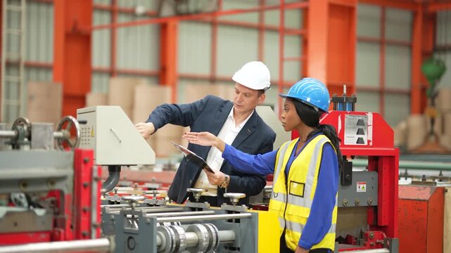 Manufacturing engineer explaining production plan during factory inspection, industrial engineering, production monitoring, technical consultation, workplace collaboration, factory operation.