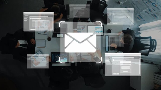 A dynamic overhead view of a business meeting showcasing professionals collaborating on laptops and digital platforms, emphasizing teamwork and innovative communication strategies. Raster