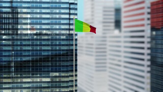 Mali Flag 3D Render Animation on Pole with Modern City Buildings - Shallow Depth of Field, Daytime View