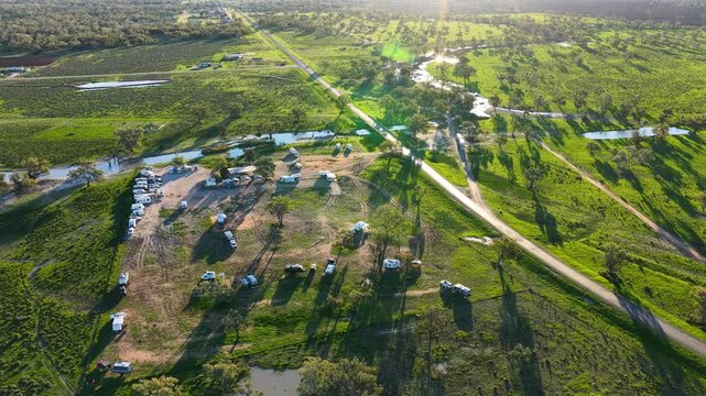 Aerial video flying over the Pilliga Artesian Bore Baths and adjacent campground in Pilliga, NSW, Australia. The naturally heated artesian baths are surrounded by native bushland
