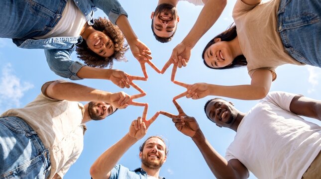 Diverse group of young friends joining hands together in a circle forming a star shape