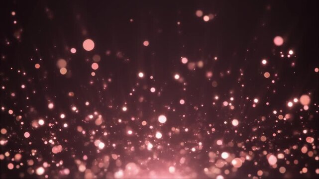 Soft glowing rose gold bokeh particles drift upward against deep charcoal background, shimmering with warm metallic glow and dreamy cinematic atmosphere in elegant slow motion.