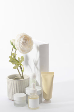 Spring sale with this clean product display. Featuring a hydrating serum, moisturizer, and floral accents to represent seasonal skin rejuvenation.