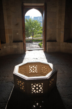 Ancient stone interior with carved well and sunlight beam in Palace of Shirvanshahs Baku with copy space