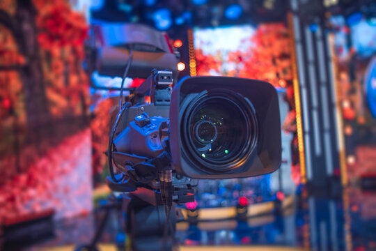 Professional studio television camera on tripod in broadcasting room with copy space